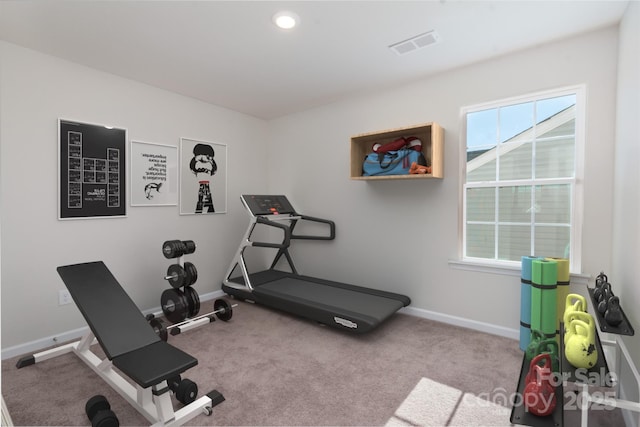 exercise room with light colored carpet