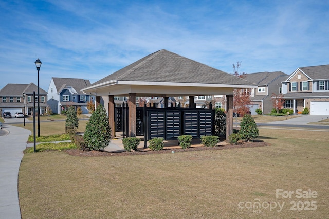 view of property's community with a yard, a gazebo, and mail boxes