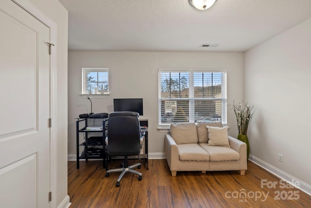 home office featuring a textured ceiling and dark hardwood / wood-style floors