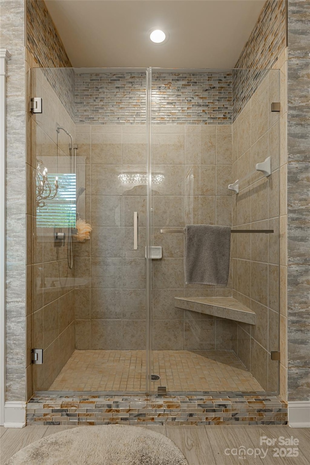 bathroom with a chandelier and walk in shower