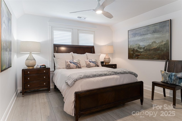 bedroom with ceiling fan, light wood-type flooring, and lofted ceiling