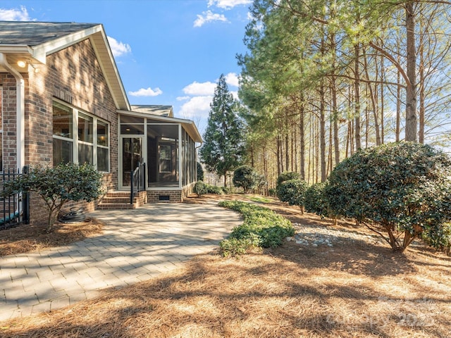 view of yard featuring a sunroom