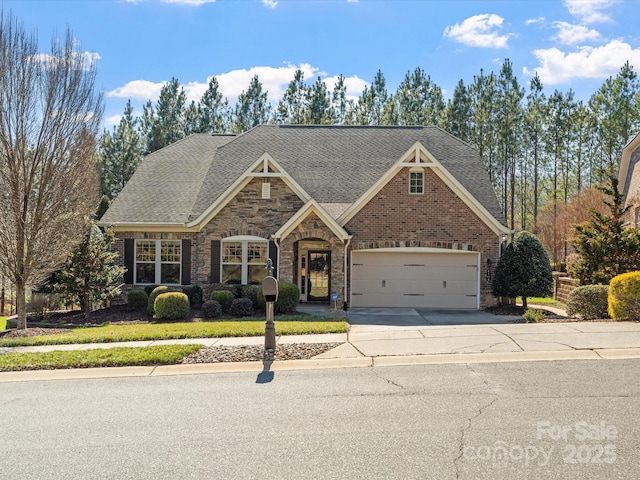 view of front of property with concrete driveway, brick siding, an attached garage, and a shingled roof