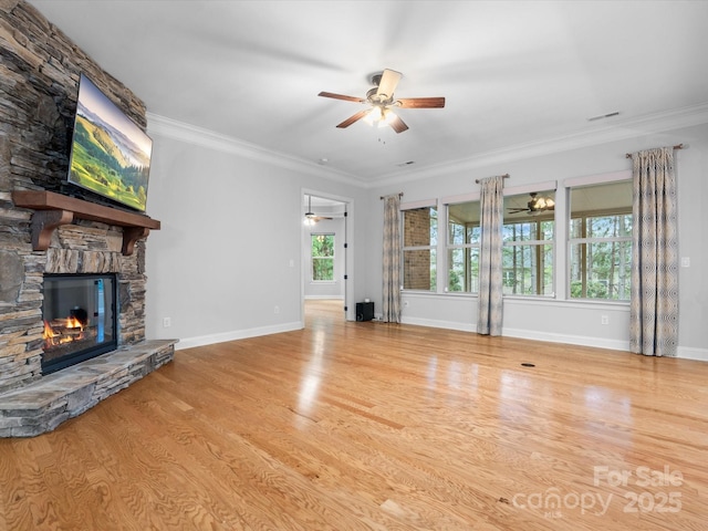 unfurnished living room with ornamental molding, a fireplace, ceiling fan, and wood finished floors