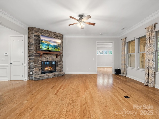 unfurnished living room with ornamental molding, a fireplace, and light wood-style flooring