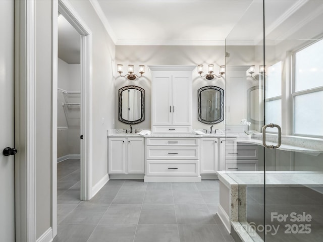 bathroom with double vanity, a stall shower, ornamental molding, tile patterned floors, and a sink