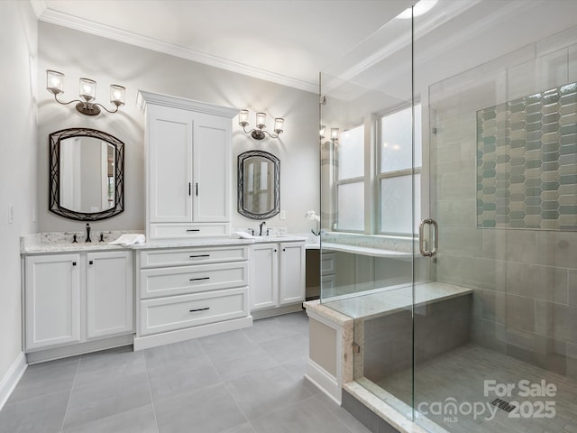 bathroom featuring double vanity, ornamental molding, a stall shower, and a sink