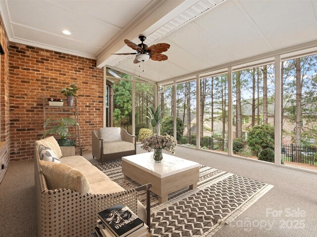 sunroom / solarium featuring ceiling fan and lofted ceiling with beams