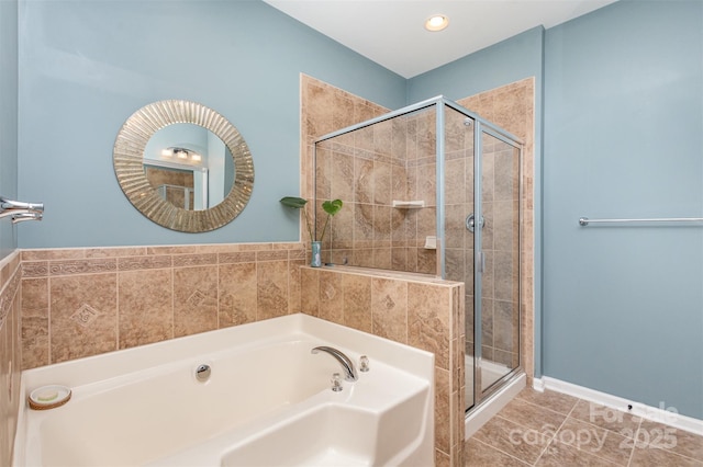 bathroom with tile patterned floors and separate shower and tub