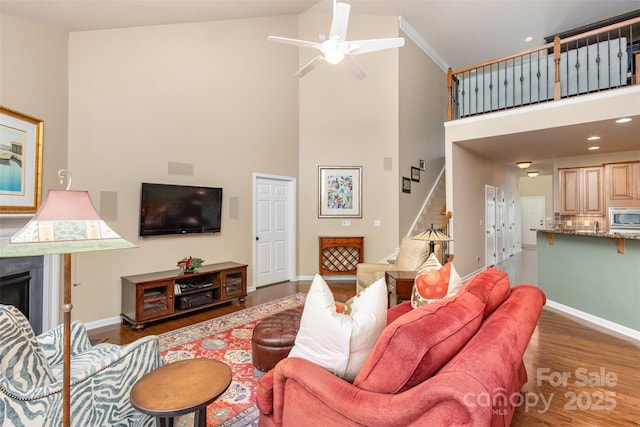 living room featuring high vaulted ceiling, ceiling fan, and dark hardwood / wood-style flooring