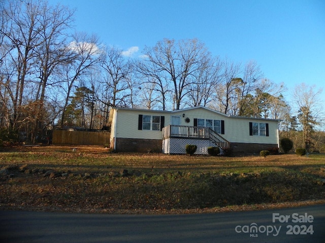 ranch-style home with a wooden deck