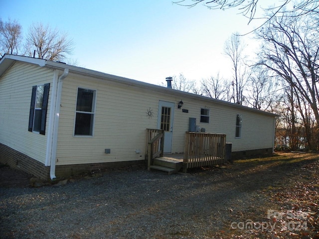 back of house with a wooden deck