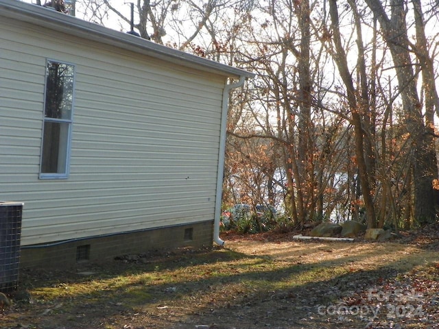 view of side of property featuring central air condition unit