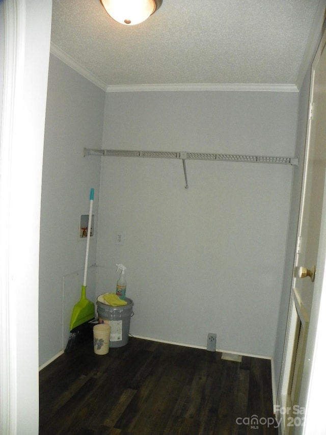 clothes washing area featuring hookup for a washing machine, a textured ceiling, ornamental molding, and dark wood-type flooring