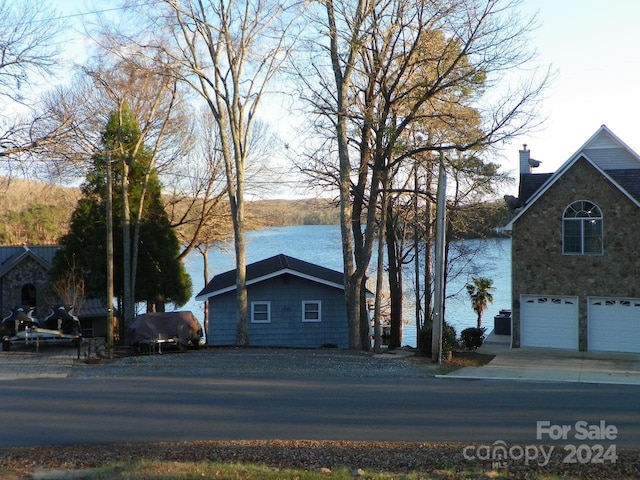 view of front of property featuring a water view and a garage