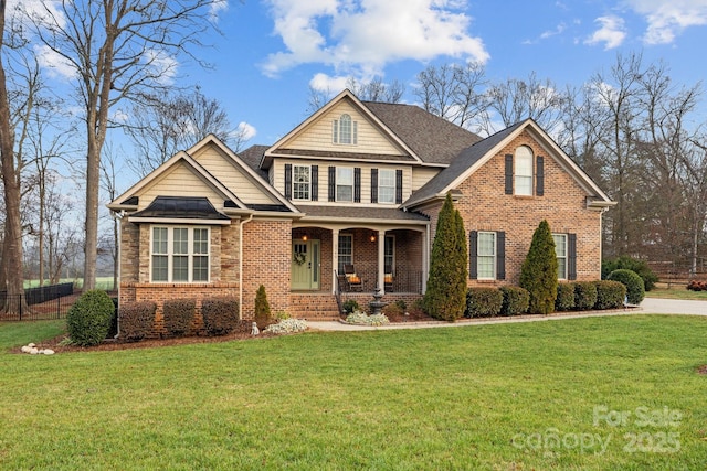 view of front of house with a front yard and a porch