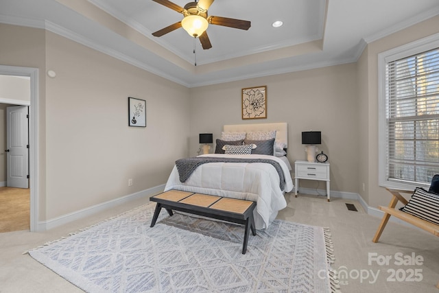 bedroom with carpet, ceiling fan, a raised ceiling, and ornamental molding