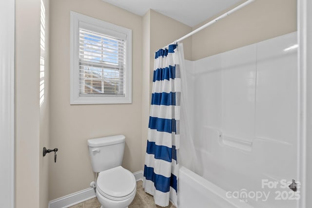 bathroom featuring tile patterned flooring, toilet, and shower / tub combo with curtain