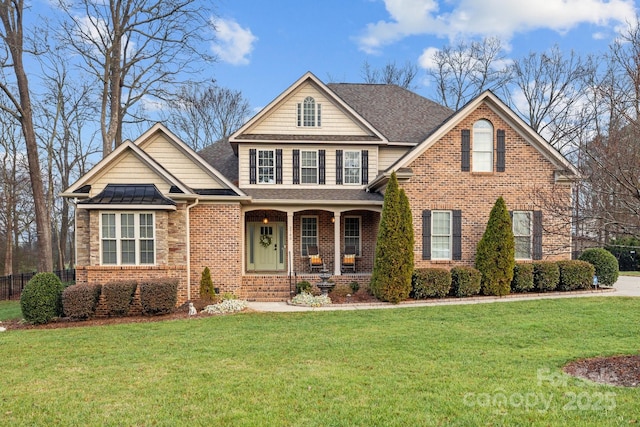 front facade featuring a front lawn and covered porch