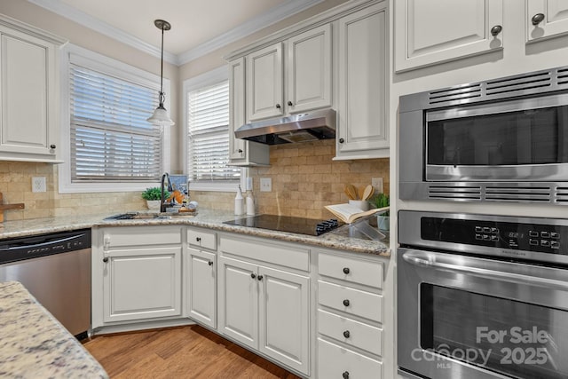 kitchen with sink, crown molding, light stone countertops, appliances with stainless steel finishes, and white cabinetry