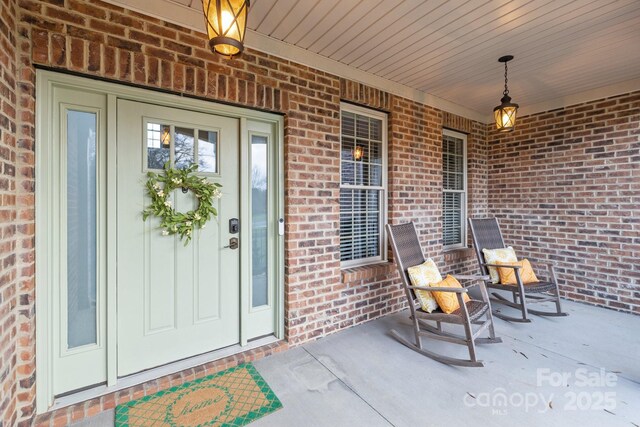 view of exterior entry featuring a porch