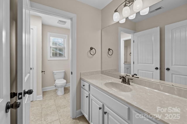 bathroom with tile patterned floors, vanity, and toilet