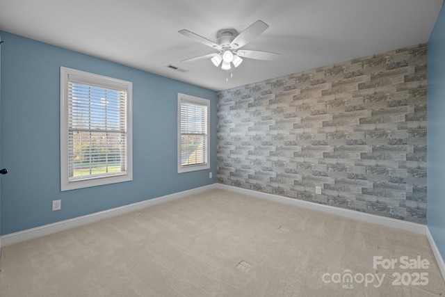 spare room with light colored carpet and ceiling fan