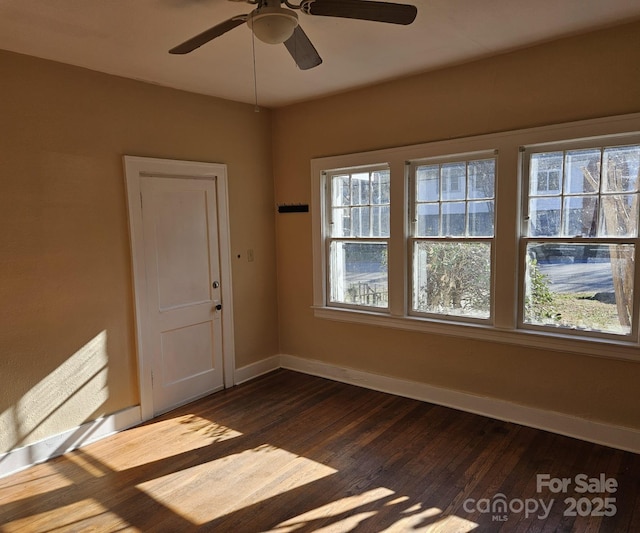 unfurnished room featuring ceiling fan and dark hardwood / wood-style floors