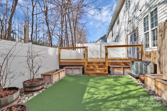 view of yard featuring a wooden deck and central air condition unit