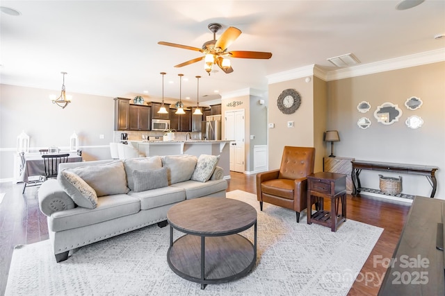 living room with crown molding, ceiling fan, and dark hardwood / wood-style floors