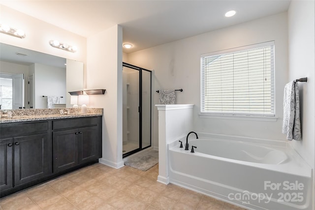 bathroom with shower with separate bathtub and vanity