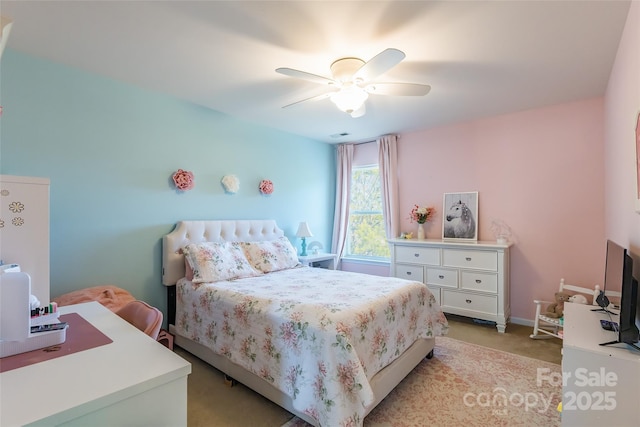 bedroom featuring ceiling fan and light carpet