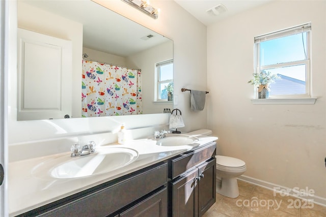 bathroom with tile patterned floors, vanity, and toilet