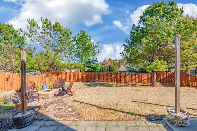 view of yard with a fire pit and a patio area