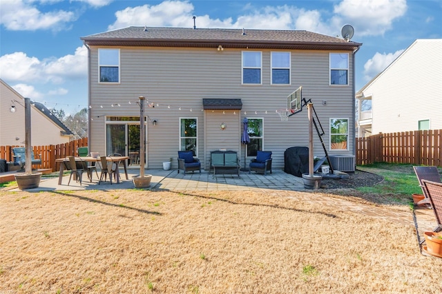 back of house featuring a patio area and a yard