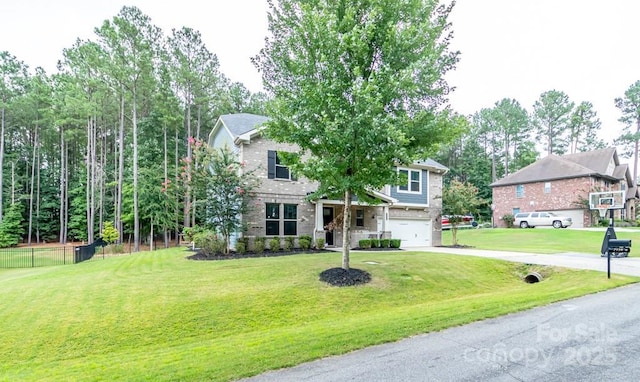 view of front of home with a garage and a front yard