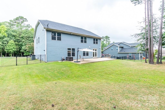 rear view of property featuring a yard and a patio