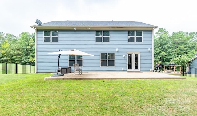 rear view of house featuring a patio area and a yard