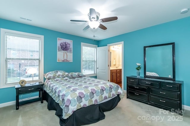 carpeted bedroom with connected bathroom and ceiling fan