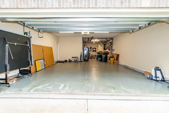 garage with a garage door opener and water heater