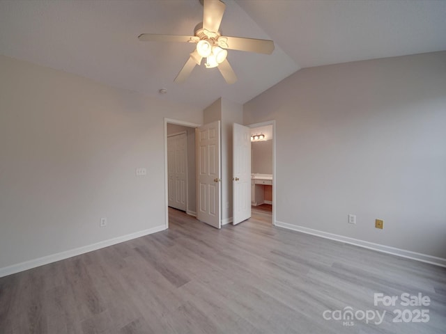 unfurnished bedroom featuring light wood-type flooring, vaulted ceiling, and ceiling fan