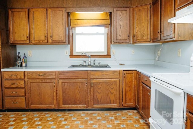 kitchen featuring white range oven and sink