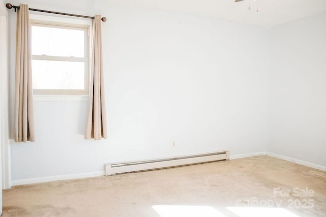 spare room featuring carpet floors, baseboard heating, and ceiling fan