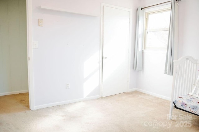 unfurnished bedroom featuring light colored carpet