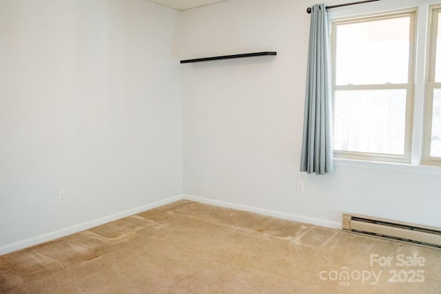 carpeted spare room featuring baseboard heating