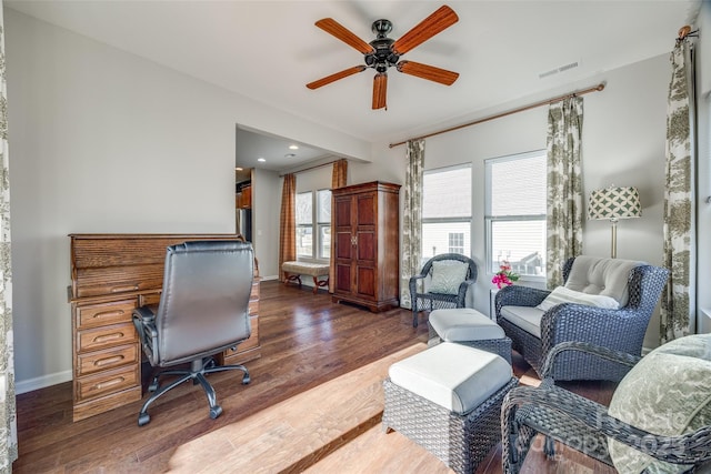 home office with dark hardwood / wood-style floors and ceiling fan