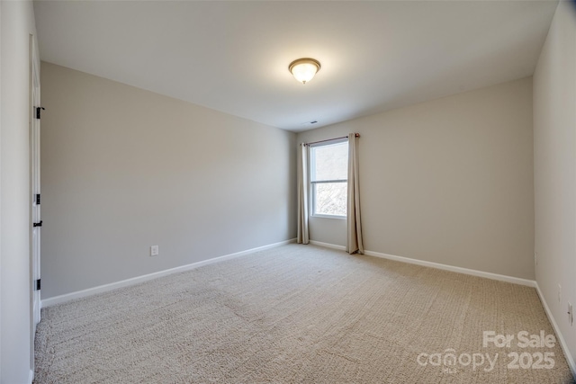 unfurnished room featuring light carpet