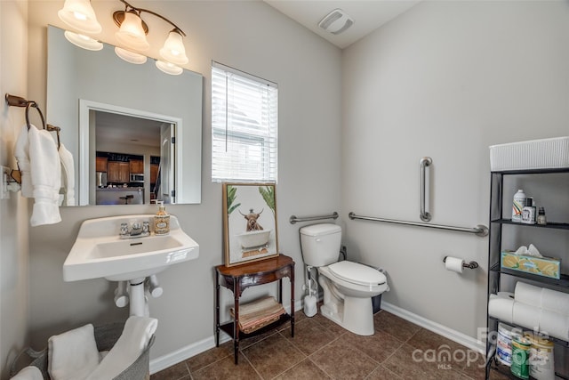 bathroom featuring tile patterned flooring, toilet, and sink