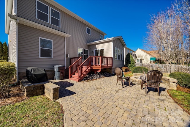 back of house with a patio, a fire pit, and a deck