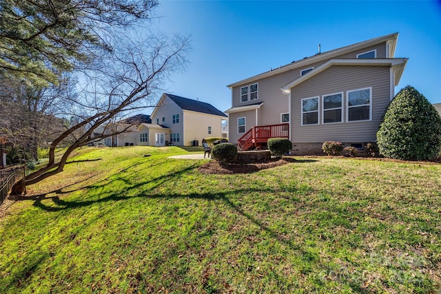 rear view of house with a lawn and a deck